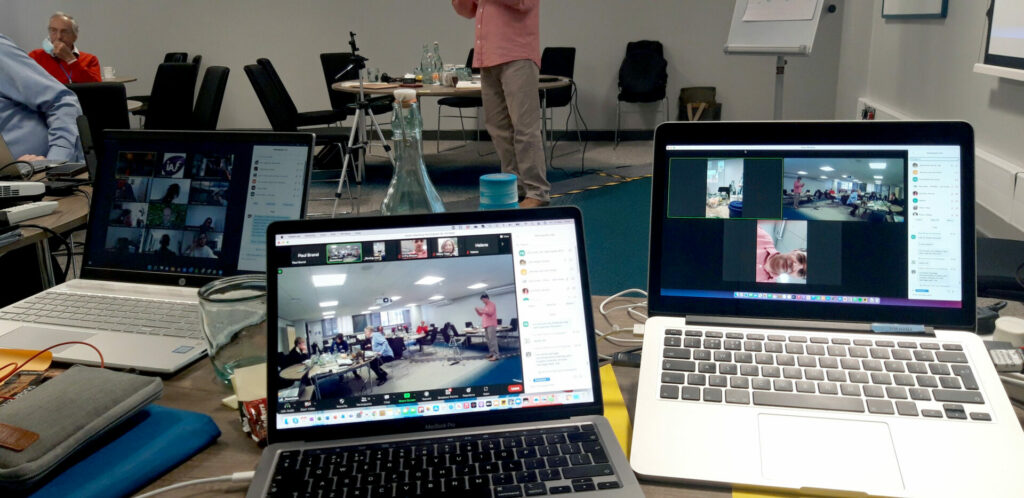 computer screens showing different views of the conference