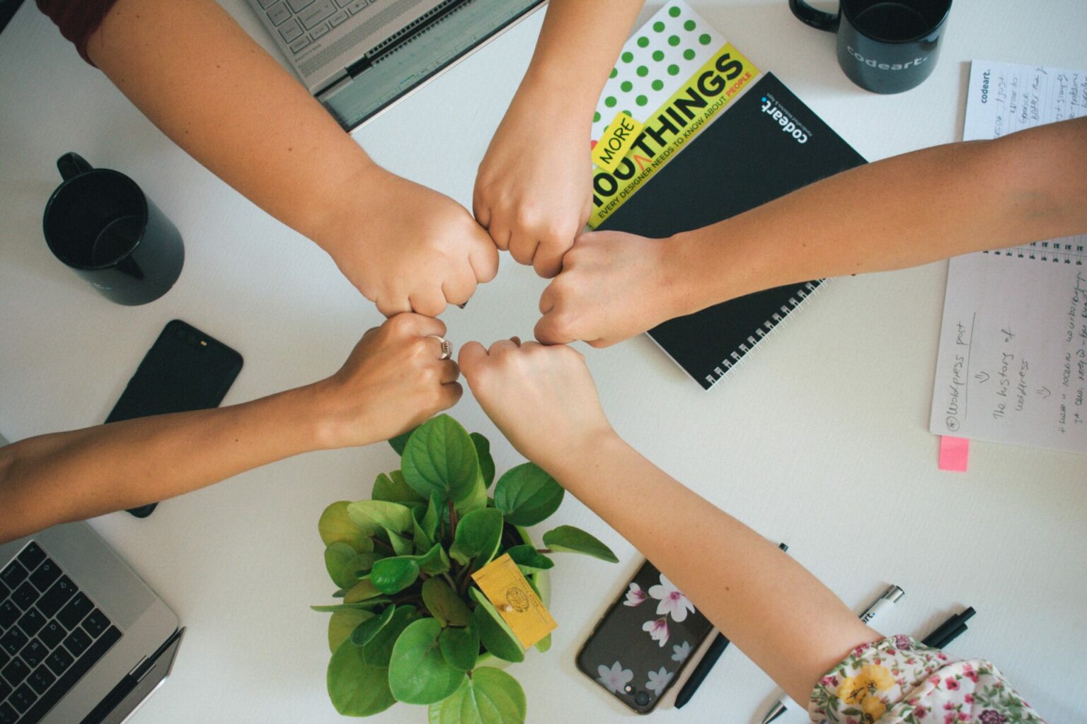 group of people fist-bumping