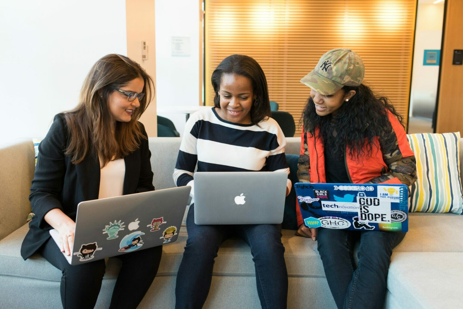 Three colleagues working together at their computers