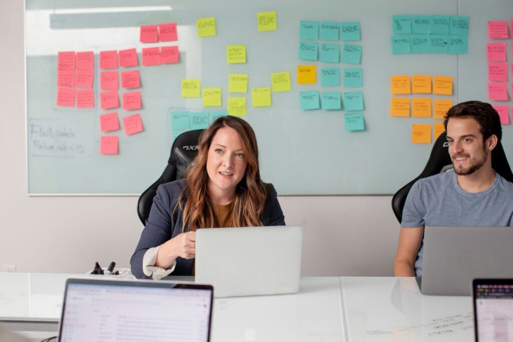 A professional woman working in front of a wall full of sticky notes