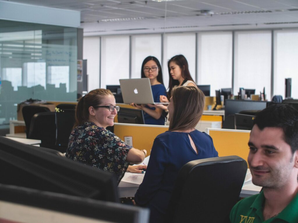 Colleagues working around computers in an office space