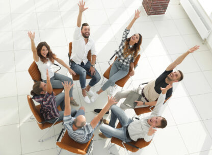 People sat in a circle playing a team building game.