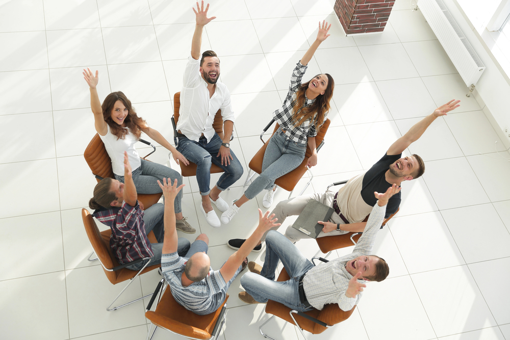 People sat in a circle playing a team building game.