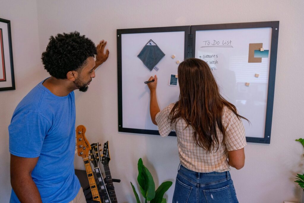 A professional woman writing on a whiteboard in an office space