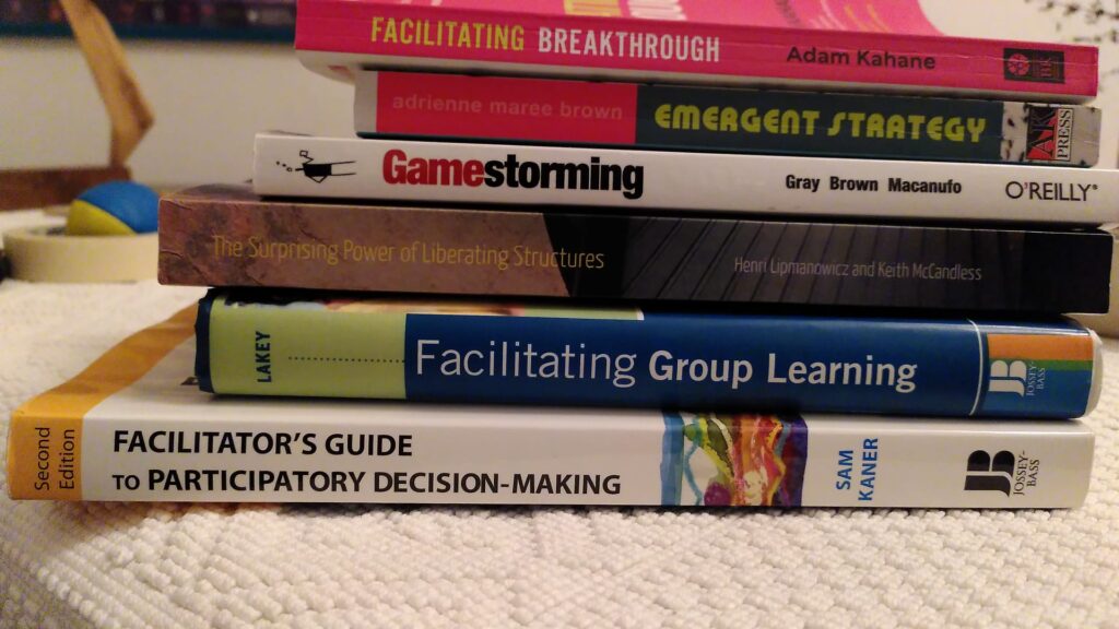 a pile of facilitation books